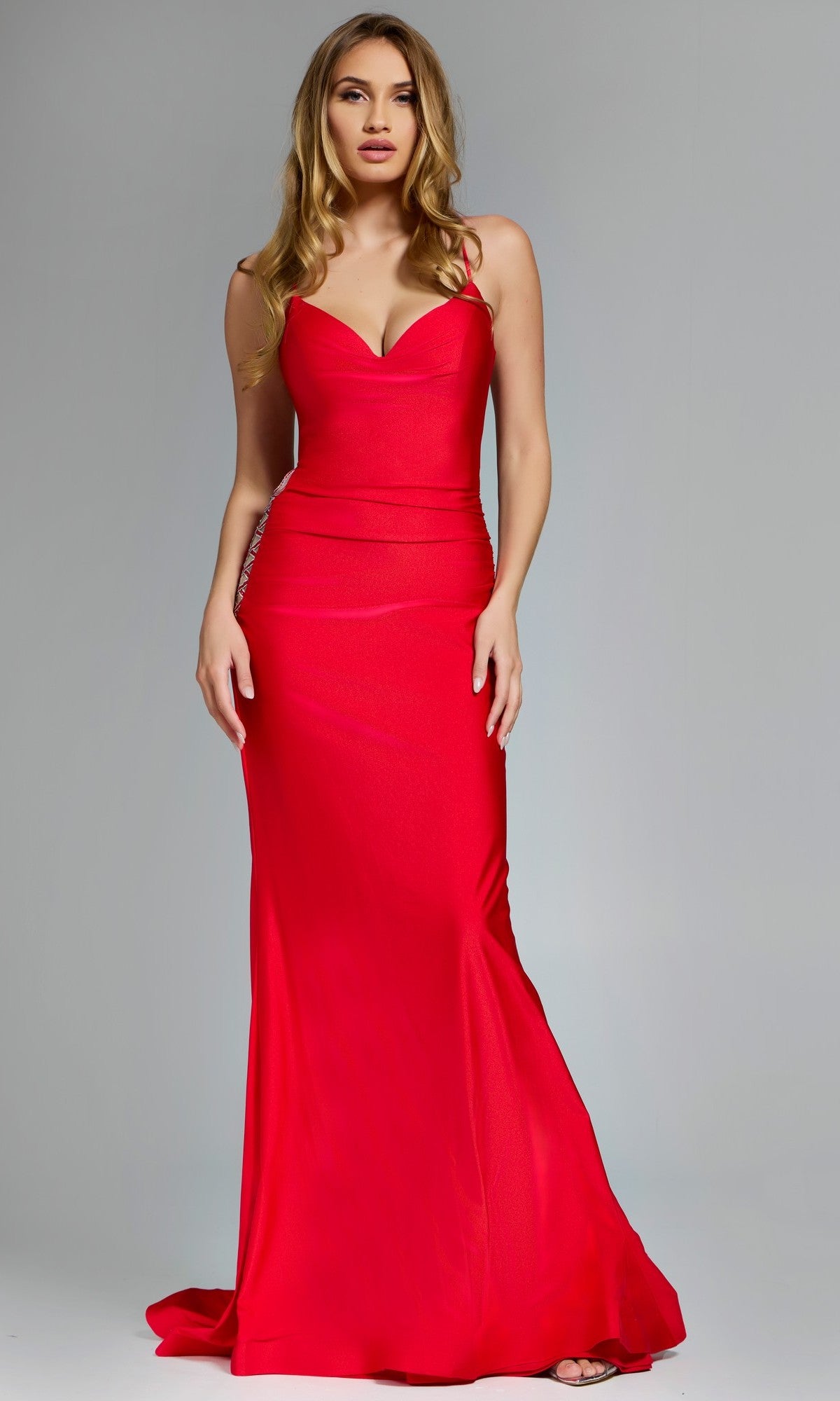 Red evening gown on a model against a gray background